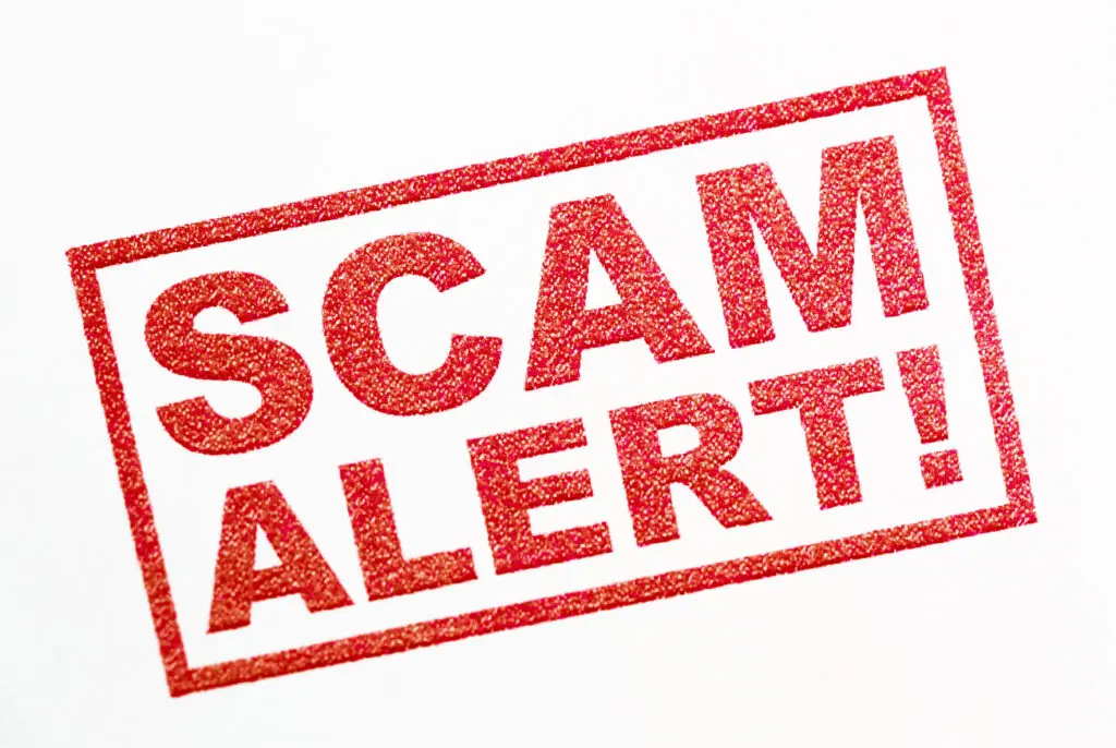 scam alert - red text stamp on white background