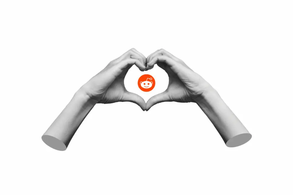How We Learned to Love Reddit Collage art of two hands making a heart sign with the Reddit logo in the middle