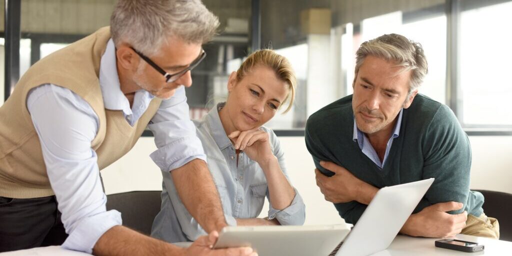 Business people in a meeting using tablet