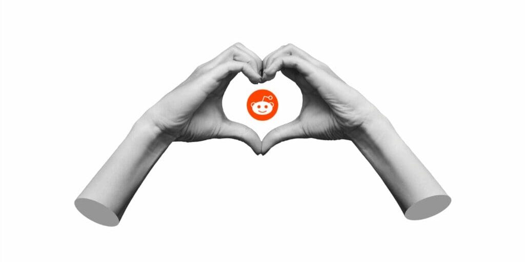 Collage art of two hands making a heart sign with the Reddit logo in the middle