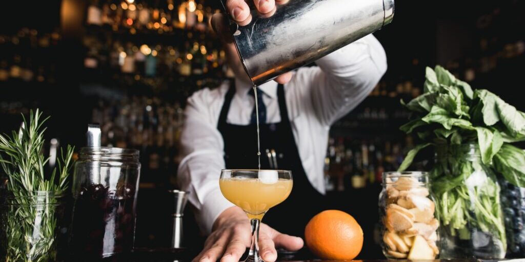Bartender pouring cocktail